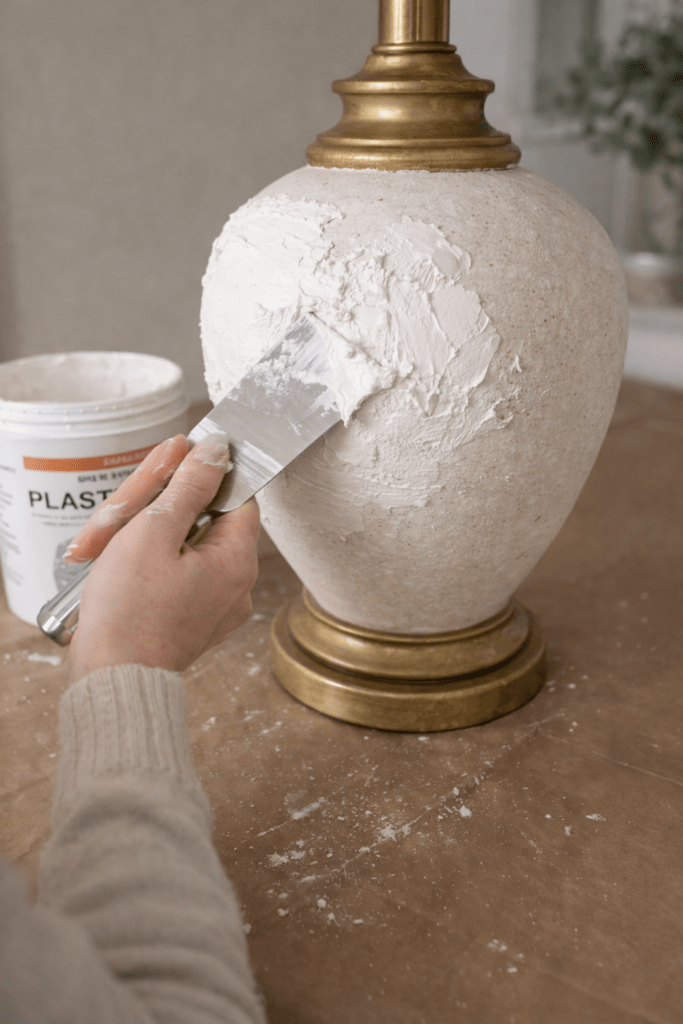 DIY plaster lamp makeover showing textured finish being applied to ceramic thrift store lamp base