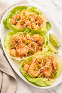 Copycat Bonefish Grill Bang Bang Shrimp Lettuce Wraps with crispy shrimp, creamy spicy sauce, cabbage, carrots, and green onions.
