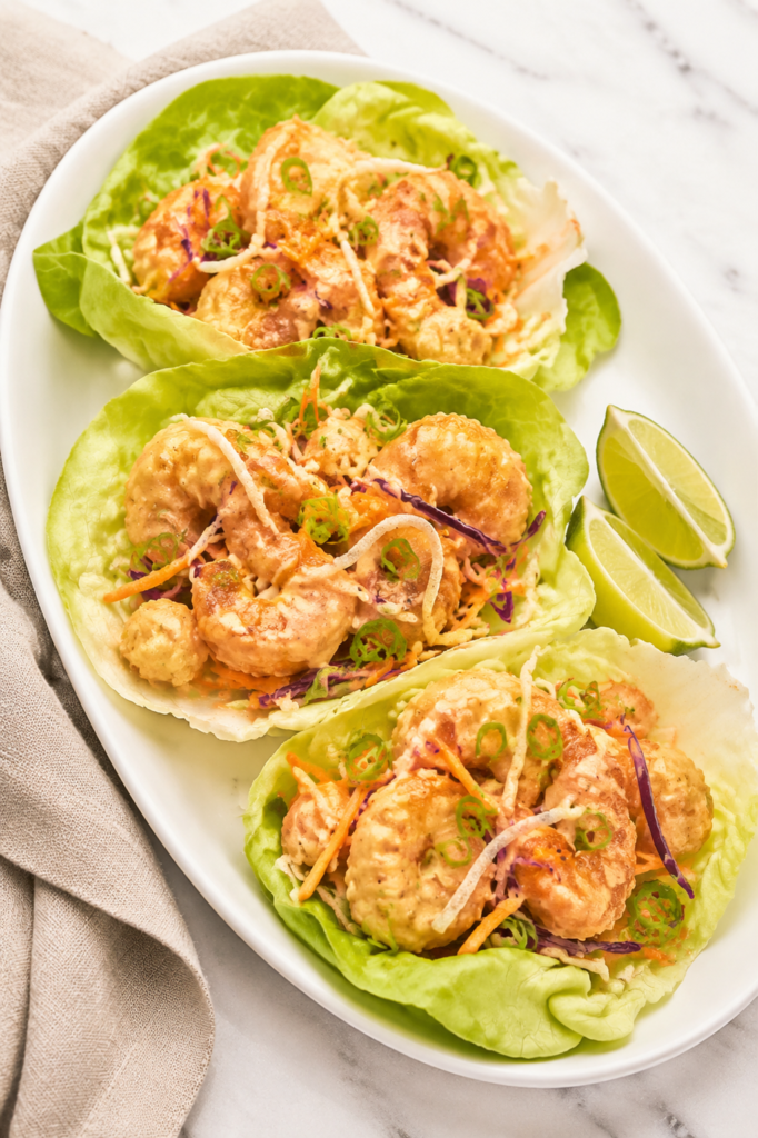 Copycat Bonefish Grill Bang Bang Shrimp Lettuce Wraps with crispy shrimp, creamy spicy sauce, cabbage, carrots, and green onions.