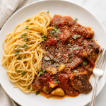 Tender steak pizzaiola in rich tomato sauce served with spaghetti