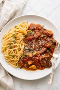 Tender steak pizzaiola in rich tomato sauce served with spaghetti