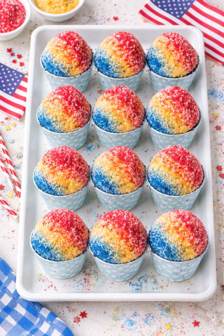 Bird’s-eye view of snow cone cupcakes lined up on a white serving tray