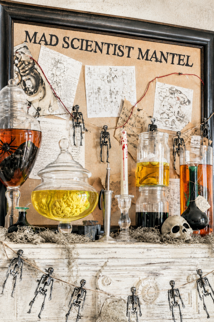 Bright vintage-inspired mad scientist Halloween mantel decorated with specimen jars, skeleton garland, anatomy sketches, skull accents, and spooky laboratory decor displayed on a farmhouse-style fireplace mantel.