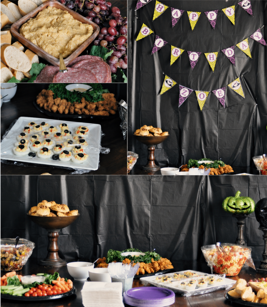 Witch-themed Halloween party buffet with deviled egg eyeballs, chicken fingers, vegetables, dip, bread and purple and green decorations