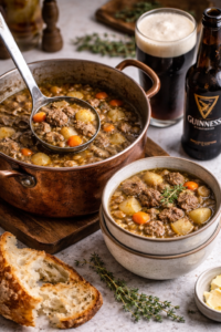 Steak and ale soup in a well-used copper pot with a ladle serving into stacked bowls, featuring tender beef, potatoes, carrots, and parsnips, with a glass of Guinness beer on the side