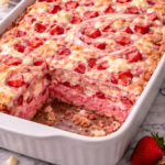 Strawberry earthquake cake with cream cheese swirls and melted white chocolate baked in a 9x13 pan