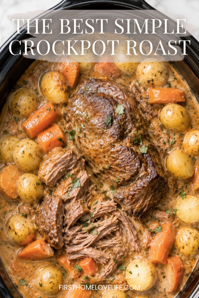 Creamy crockpot pot roast with tender shredded beef, baby potatoes, and carrots in a rich onion gravy inside a black slow cooker on a marble countertop.