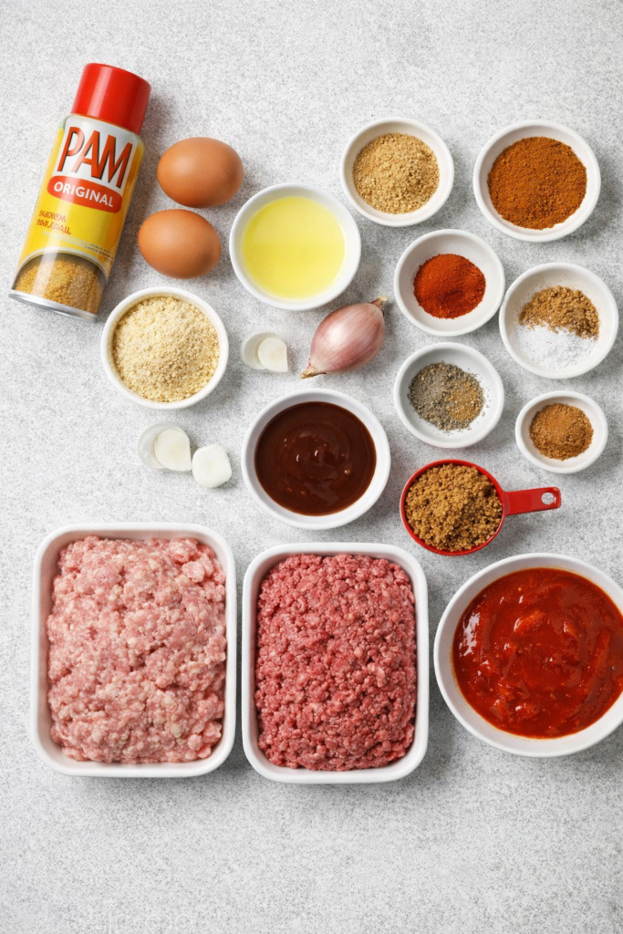Flat lay of ingredients for slow cooker sriracha BBQ meatballs including ground beef, ground pork, eggs, breadcrumbs, BBQ sauce, sriracha, spices, and PAM cooking spray