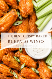 Pinterest graphic featuring crispy baked buffalo chicken wings coated in homemade buffalo sauce with celery sticks and ranch dressing on a white oval platter.
