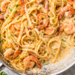 Creamy Cajun seafood boil pasta with shrimp and crab in garlic butter sauce served in skillet