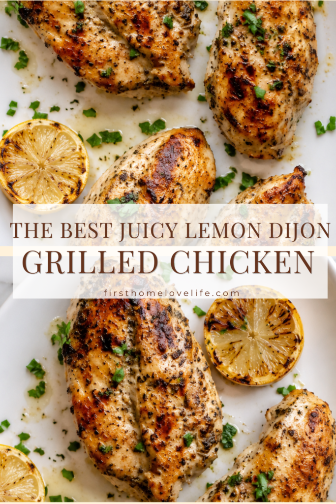Juicy grilled lemon Dijon chicken on a white serving platter with grilled lemons, fresh herbs, and a flavorful lemon Dijon marinade.