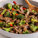Chinese beef and broccoli stir fry in a skillet with tender sliced beef, fresh broccoli, and savory garlic ginger sauce.