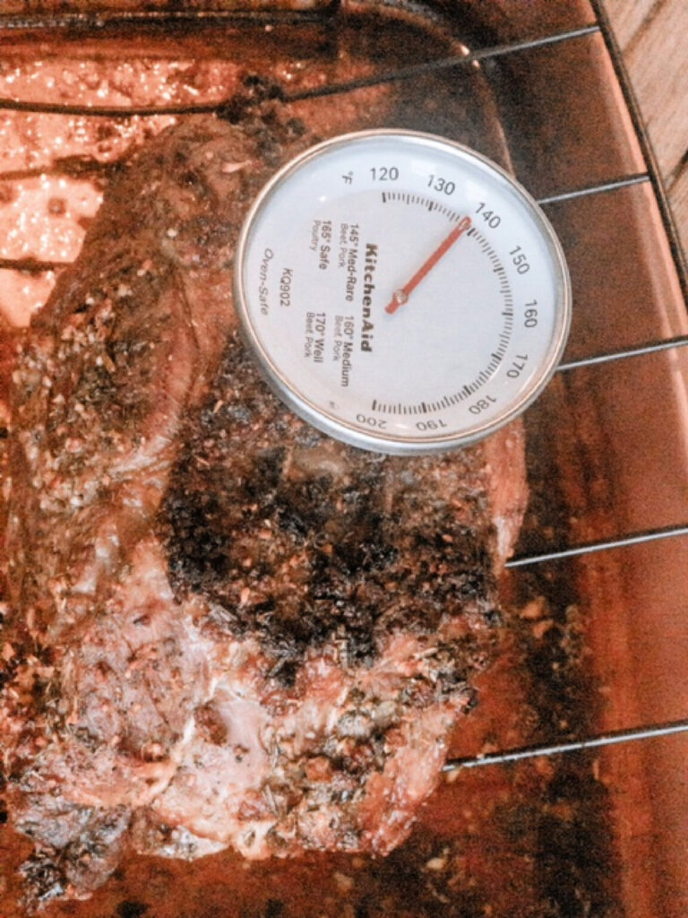 meat thermometer checking internal temperature of prime rib roast