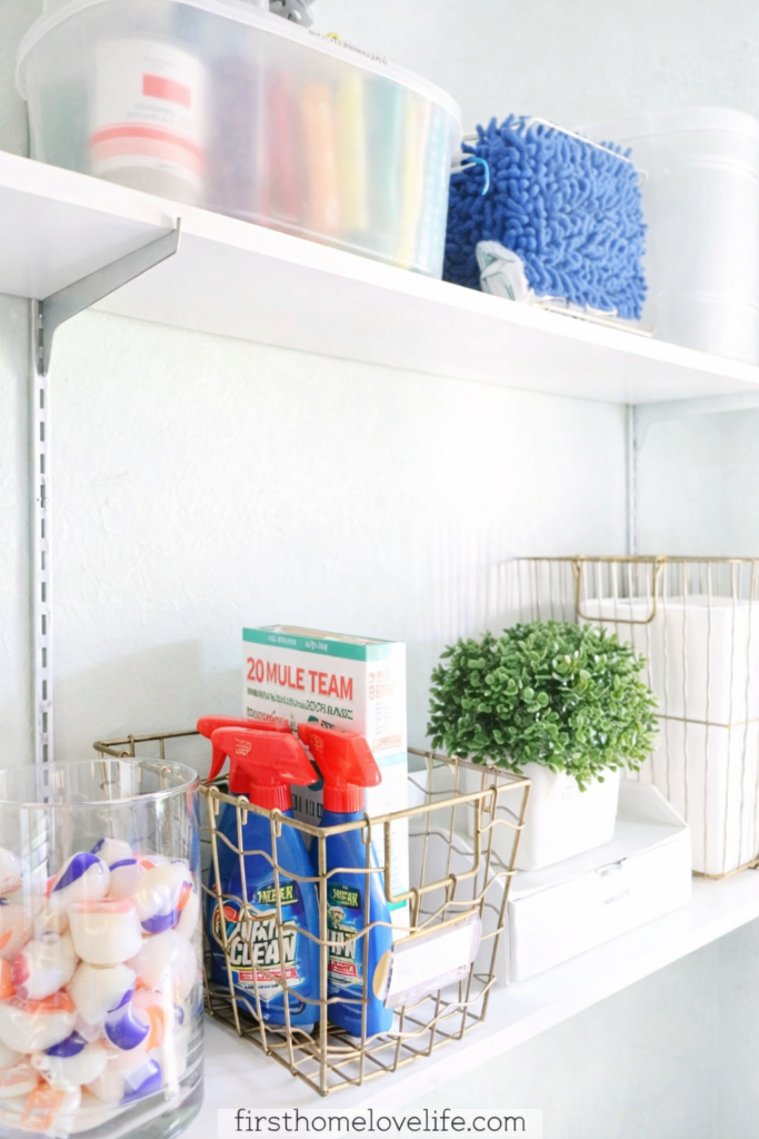 organized laundry room shelves with baskets cleaning supplies and detergent pods