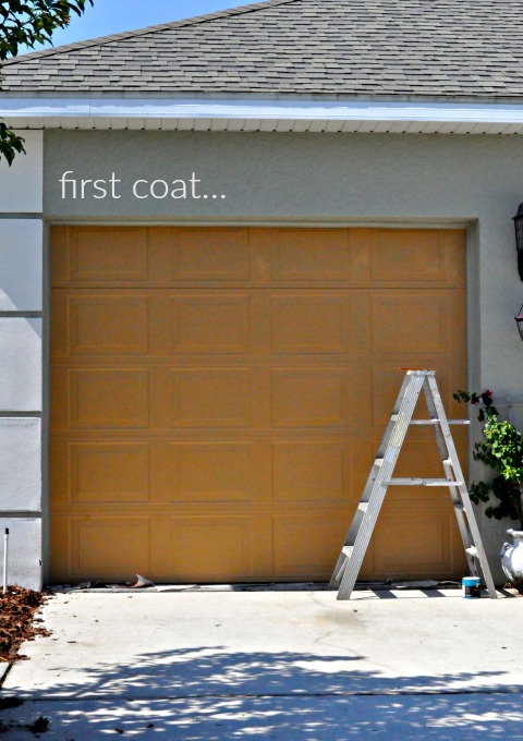 first coat using behr burnished caramel on the garage via firsthomelovelife.com