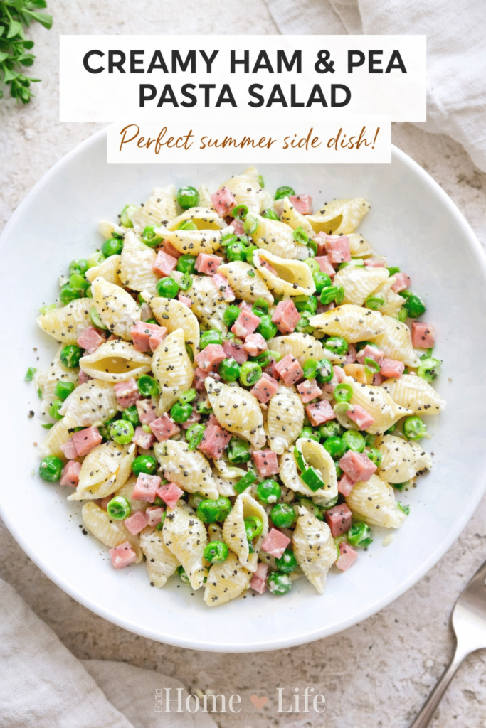Creamy ham and pea pasta salad in a white bowl with shell pasta, green peas, diced ham, and poppy seeds, styled in a bright bird’s-eye view with a clean kitchen background.