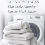 stack of clean white towels in laundry basket with washing machine behind showing 10 laundry hacks that make laundry day easier