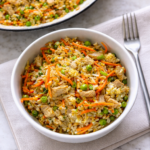 Easy 15 minute pork fried rice served in a white bowl on a neutral linen towel over a marble countertop.