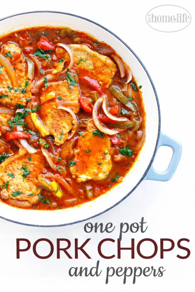 One pot pork chops and peppers in white enamel skillet on clean white background