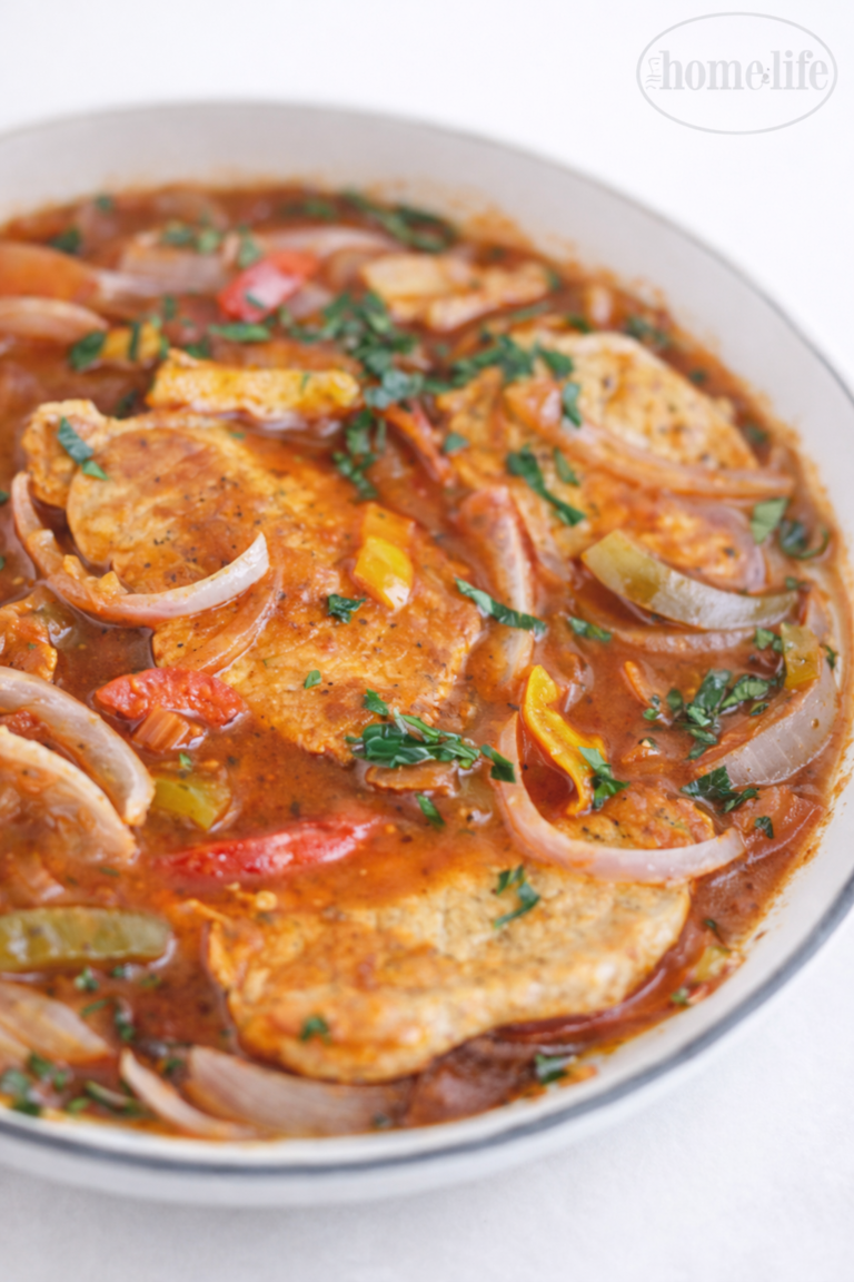 Close up of one pot pork chops and peppers in tomato sauce with onions and parsley