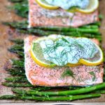Healthy sheet pan dinner idea | Salmon with lemon and asparagus with a garlic yogurt sauce via firsthomelovelife.com