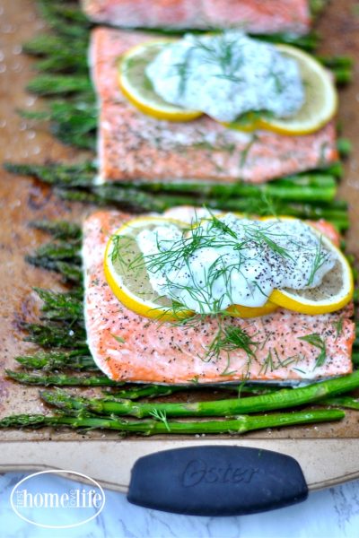 Healthy sheet pan dinner idea | Salmon with lemon and asparagus with a garlic yogurt sauce via firsthomelovelife.com