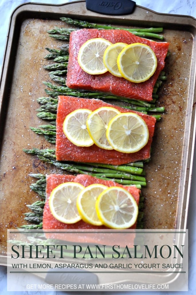 Healthy sheet pan dinner idea | Salmon with lemon and asparagus with a garlic yogurt sauce via firsthomelovelife.com