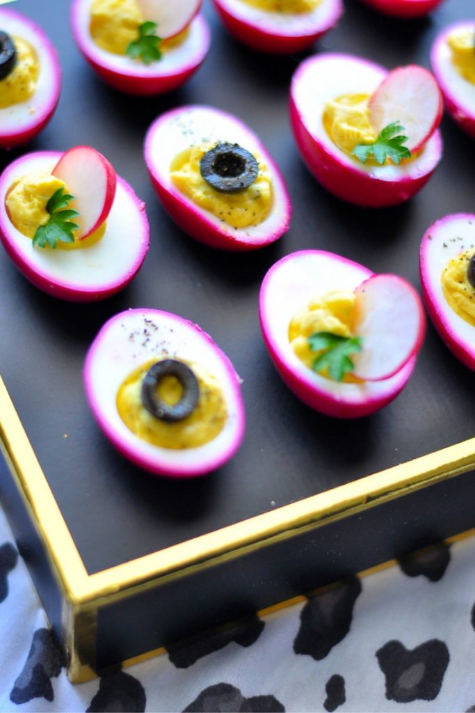 PICKLED BEET DEVILED EGGS SHOULD BE CALLED PARTY EGGS! THEY'RE HOT PINK AND DELICIOUS! GET THE RECIPE FOR THIS FUN APPETIZER AT FIRSTHOMELOVELIFE.COM