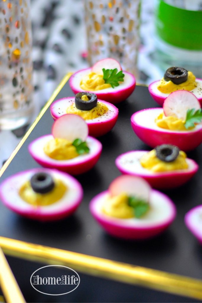 PICKLED BEET DEVILED EGGS SHOULD BE CALLED PARTY EGGS! THEY'RE HOT PINK AND DELICIOUS! GET THE RECIPE FOR THIS FUN APPETIZER AT FIRSTHOMELOVELIFE.COM