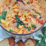 Creamy Tuscan chicken noodle soup is the perfect cold weather meal! Loaded with chicken, noodles, sun dried tomatoes and spinach in a creamy garlic tomato broth! via firsthomelovelife.com