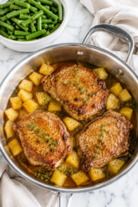 Easy pineapple pork chops cooked in a one pan skillet with fresh pineapple chunks, thyme, and a sweet savory pineapple glaze served with green beans.