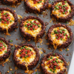 Bacon jalapeño cream cheese and cheddar meatloaf cups baked in a muffin pan with melted cheese centers and crispy bacon