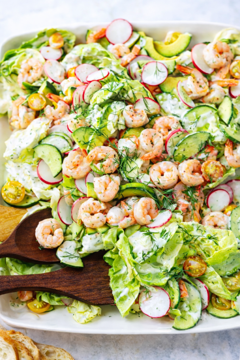 Creamy dill shrimp salad with avocado, cucumber, radishes, and tomatoes served on butter lettuce with a rich mayo sour cream dressing.