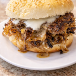 Depression Era onion smash cheeseburger with caramelized onions and melted American cheese on a soft sesame bun