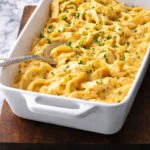 Creamy German noodle bake made with homemade egg noodles and Swiss cheese, baked until golden and garnished with fresh chives.