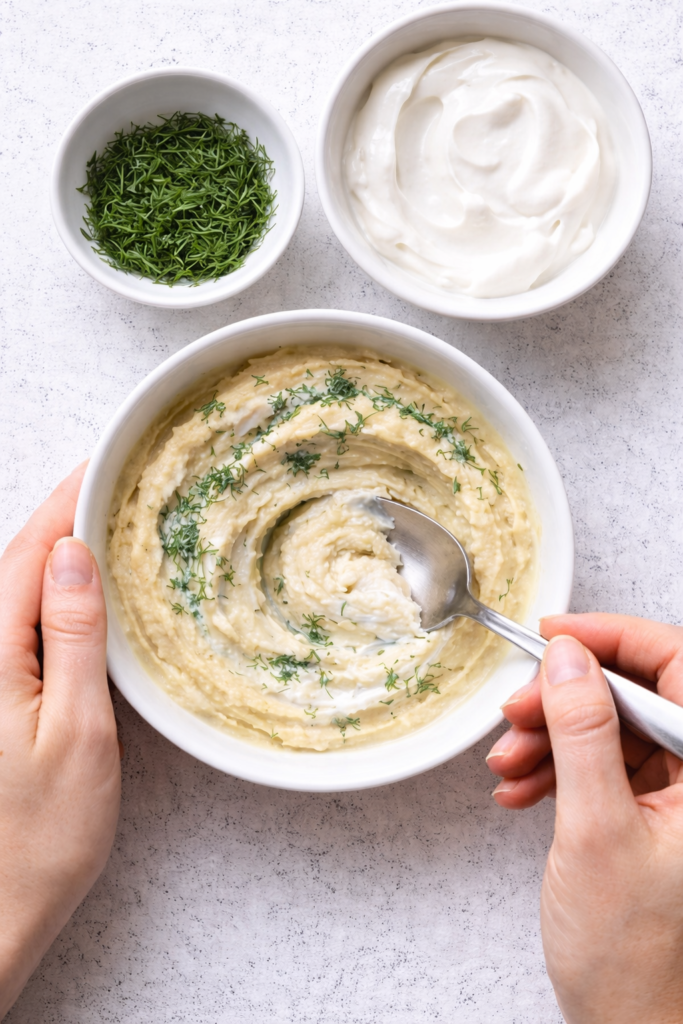 Hummus Sauce Being Made for Greek Salad Nachos