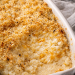 Creamy mashed cauliflower au gratin in a white baking dish with golden panko topping, warm, cheesy, and comforting.