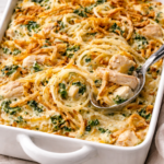 Creamy Monterey chicken spaghetti bake with rotisserie chicken, spinach, melted cheese, and crispy fried onions