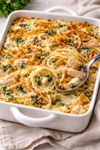 Creamy Monterey chicken spaghetti bake with rotisserie chicken, spinach, melted cheese, and crispy fried onions