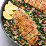 One-pan chicken scallopini with crispy breaded chicken cutlets, bacon, onions, and Swiss chard cooked in a skillet with lemon wedges.