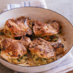 Golden baked pork chops stuffed with a savory herb breadcrumb filling, cooked in a rustic skillet and styled on a neutral linen for a cozy homemade dinner.