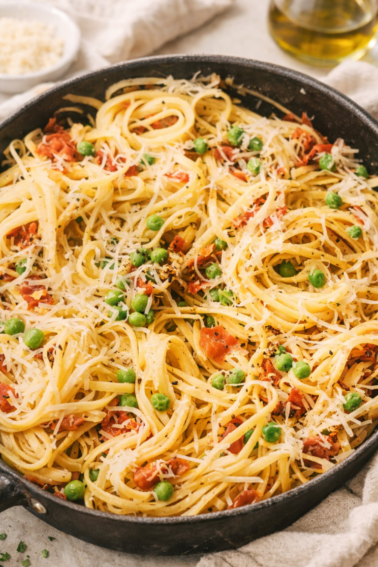 Prosciutto pasta toss made with linguine, peas, crispy prosciutto, and parmesan cheese in a skillet, an easy 20 minute weeknight dinner.