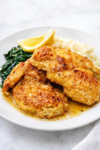 Southern garlic butter Creole chicken served with mashed potatoes and greens