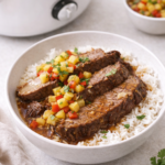 Thai-style brisket rice bowl topped with fresh pineapple relish and served with slow cooker in the background
