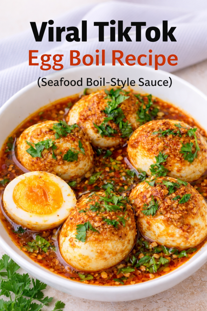 Pinterest graphic for viral egg boil recipe featuring hard-boiled eggs in spicy seafood boil butter sauce