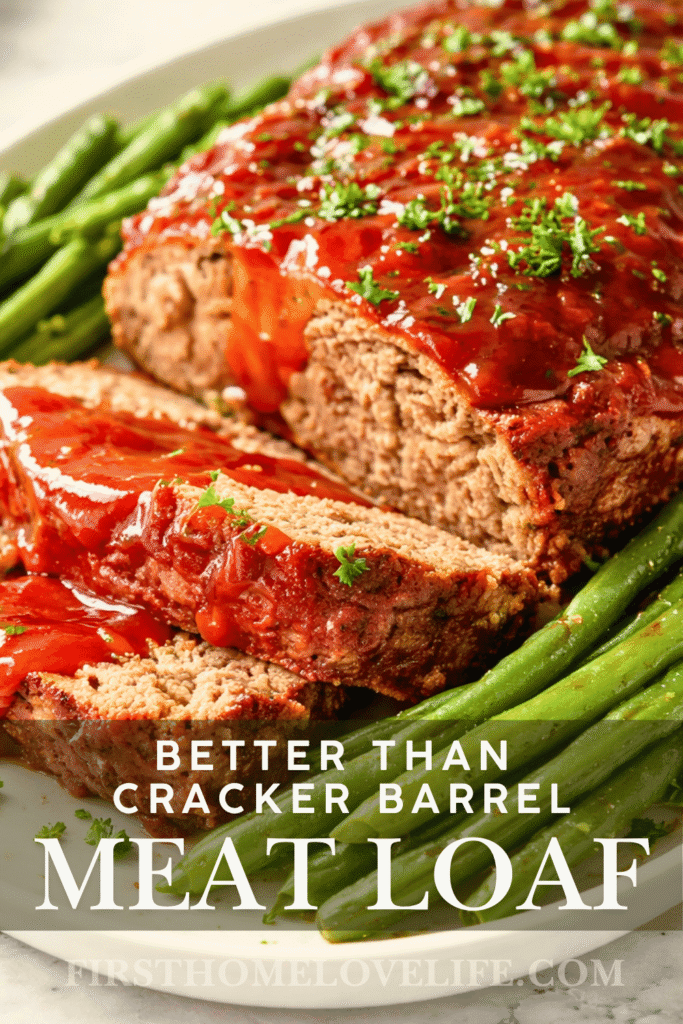 Better than Cracker Barrel copycat meatloaf with ketchup glaze and green beans on a white platter