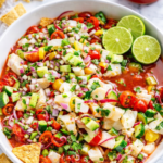 Bloody Mary ceviche with white fish, diced red onion, cucumber, tomatoes, Clamato juice, lime, and tortilla chips