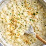 creamy Boursin mac and cheese with garlic herb sauce in a skillet on a marble countertop