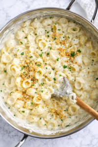 creamy Boursin mac and cheese with garlic herb sauce in a skillet on a marble countertop
