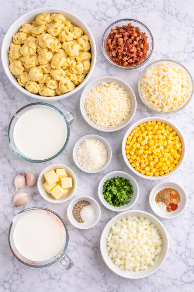 ingredients for creamy corn and bacon tortellini bake on marble counter